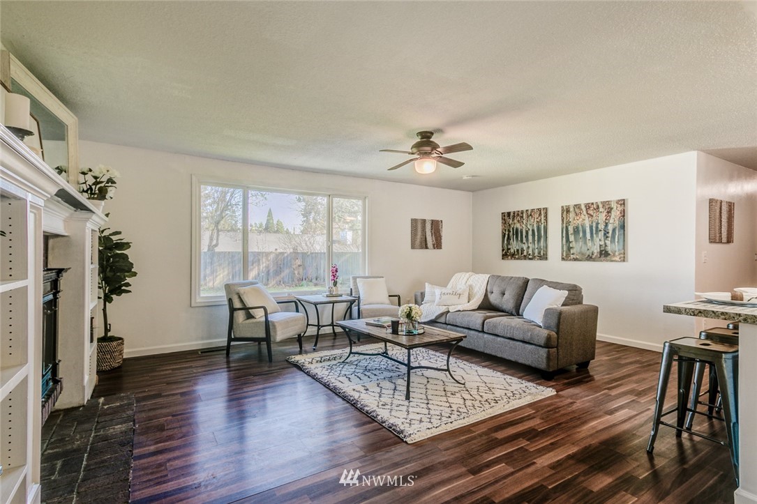 16618 124th Avenue Southeast Renton, WA 98058 - Photo 5 of 21 a living room with furniture and a table