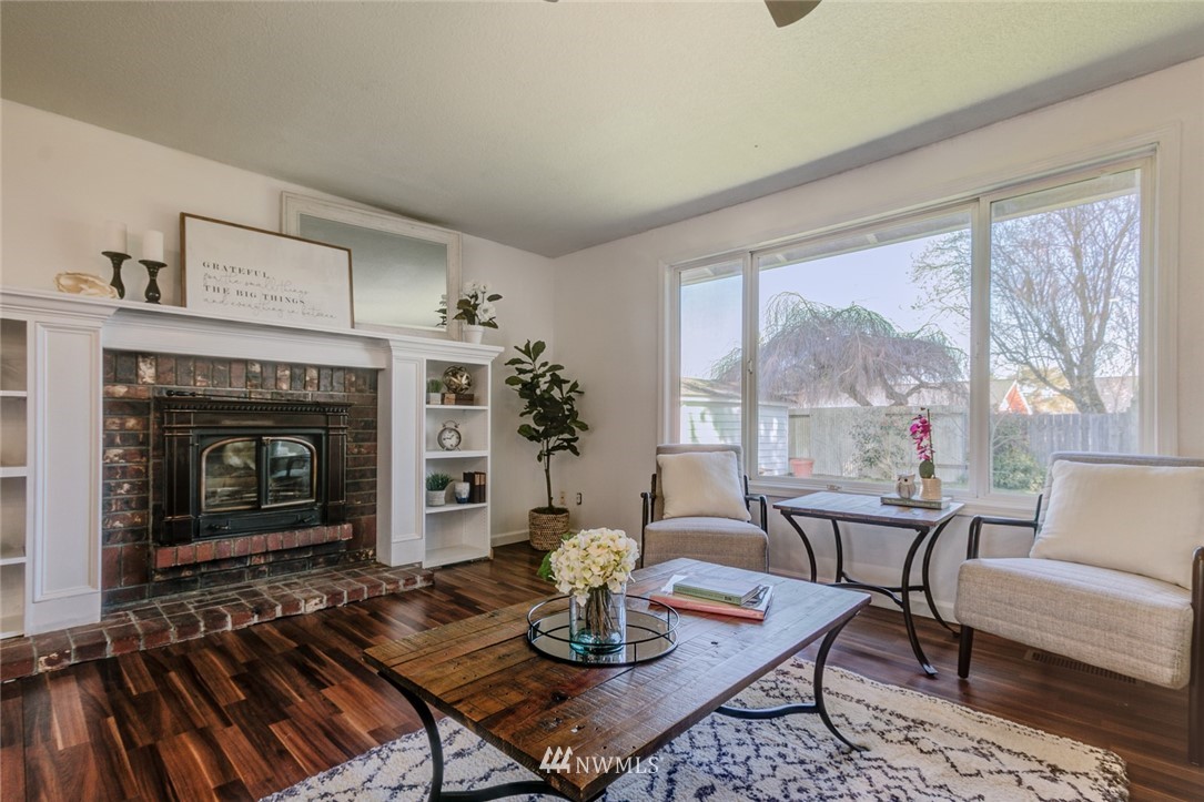 16618 124th Avenue Southeast Renton, WA 98058 - Photo 6 of 21 a living room with furniture and a fireplace