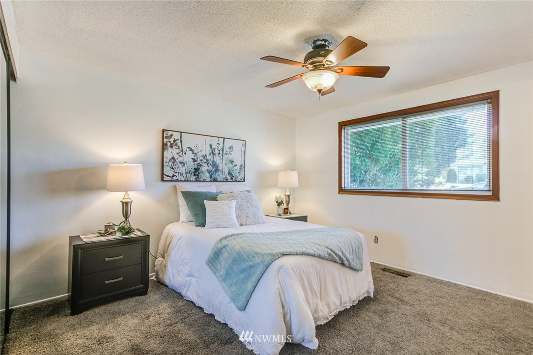 16618 124th Avenue Southeast Renton, WA 98058 - Photo 10 of 21 a bedroom with a bed and a chandelier