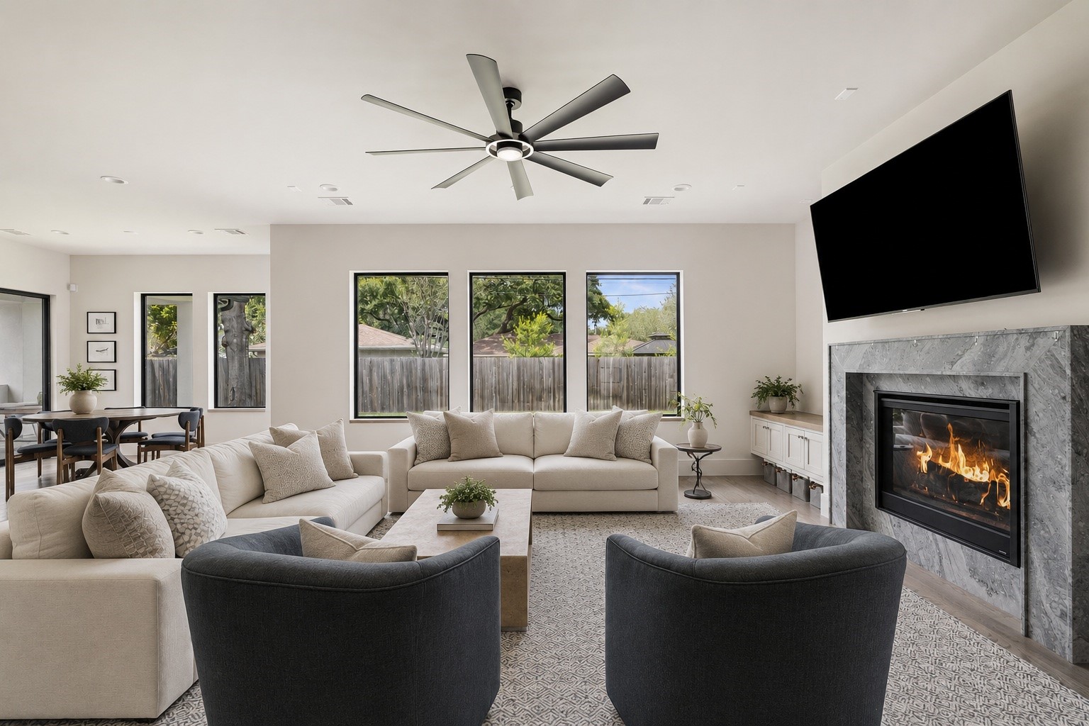 4638 Merwin Street Houston, TX 77027 - Photo 4 of 42 The spacious living room is anchored by a fireplace and framed by expansive windows overlooking the backyard.