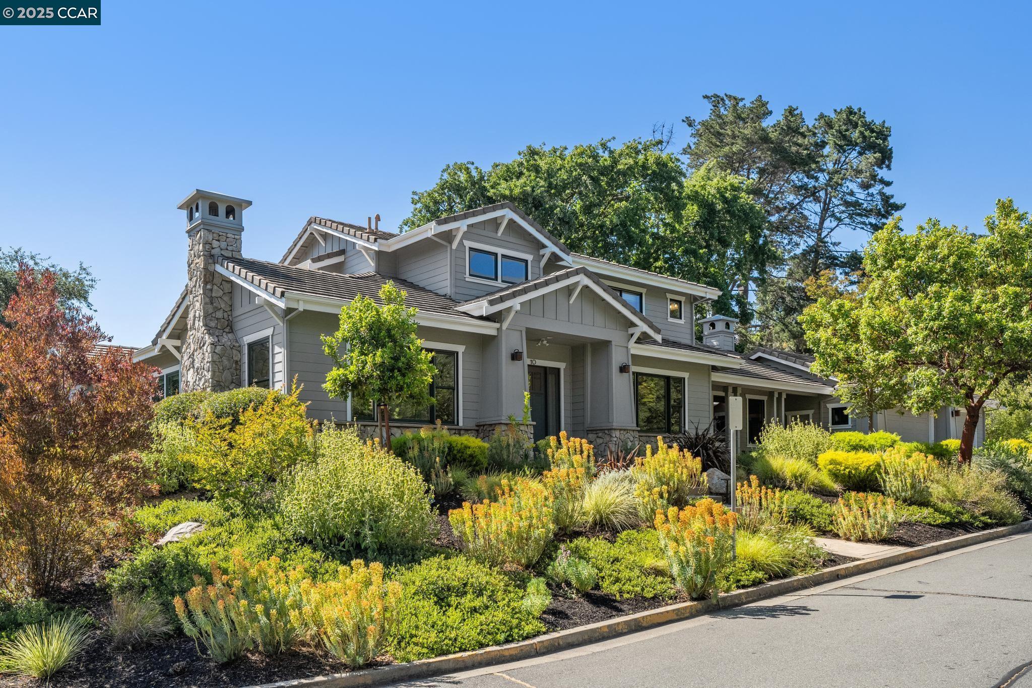a front view of a house with a garden