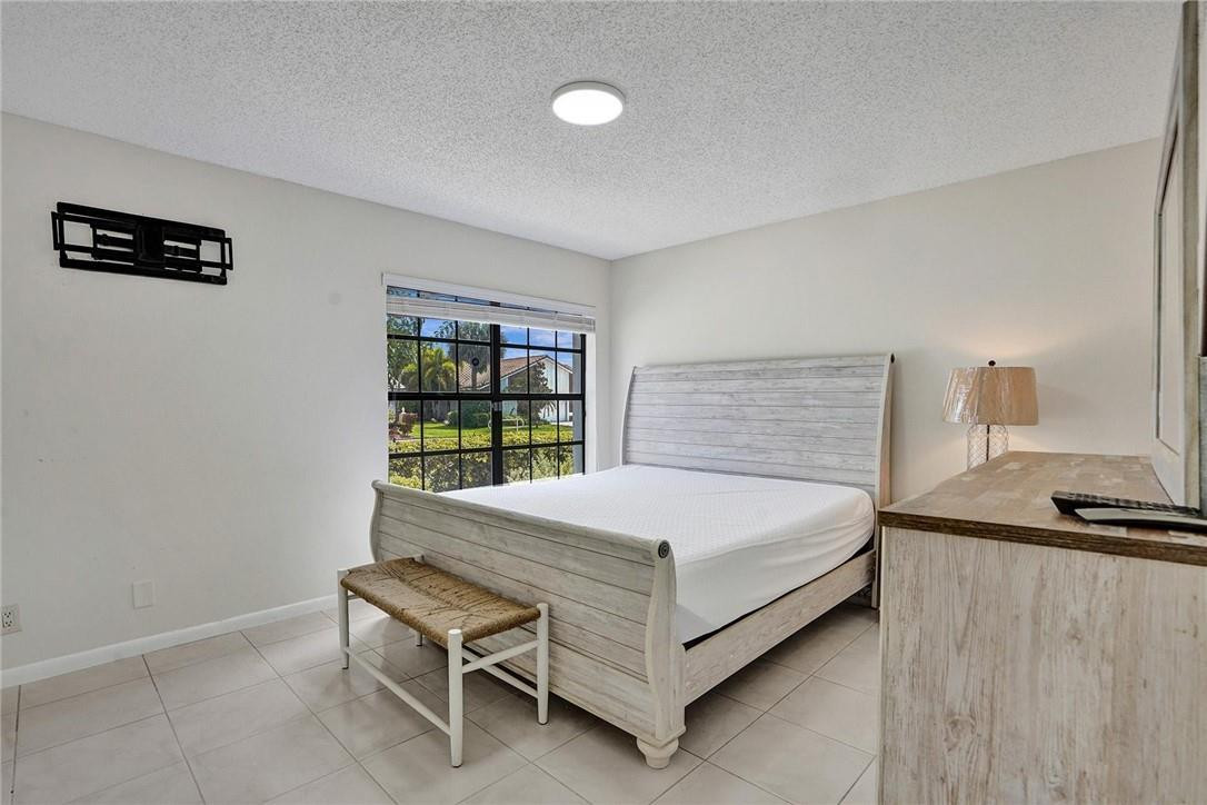 10066 Camelback Lane Boca Raton, FL 33498 - Photo 15 of 34 a bedroom with a bed and a window