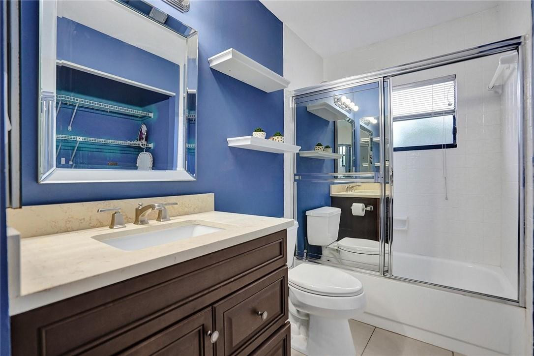 10066 Camelback Lane Boca Raton, FL 33498 - Photo 17 of 34 a bathroom with a sink vanity mirror and toilet