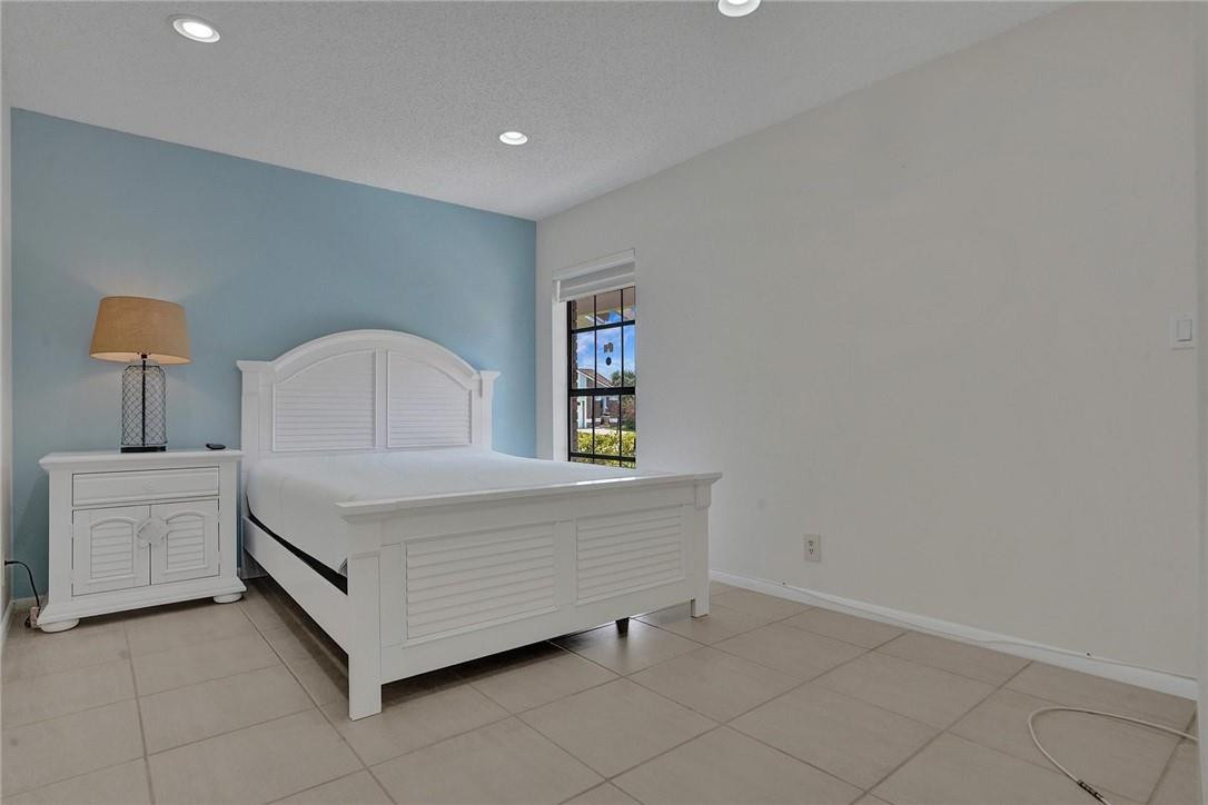 10066 Camelback Lane Boca Raton, FL 33498 - Photo 19 of 34 a room with a bed and a lamp