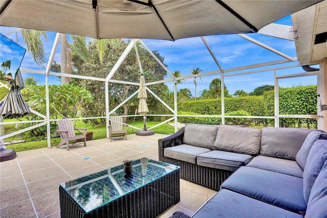 10066 Camelback Lane Boca Raton, FL 33498 - Photo 22 of 34 a view of a patio with a couch and a table and chairs