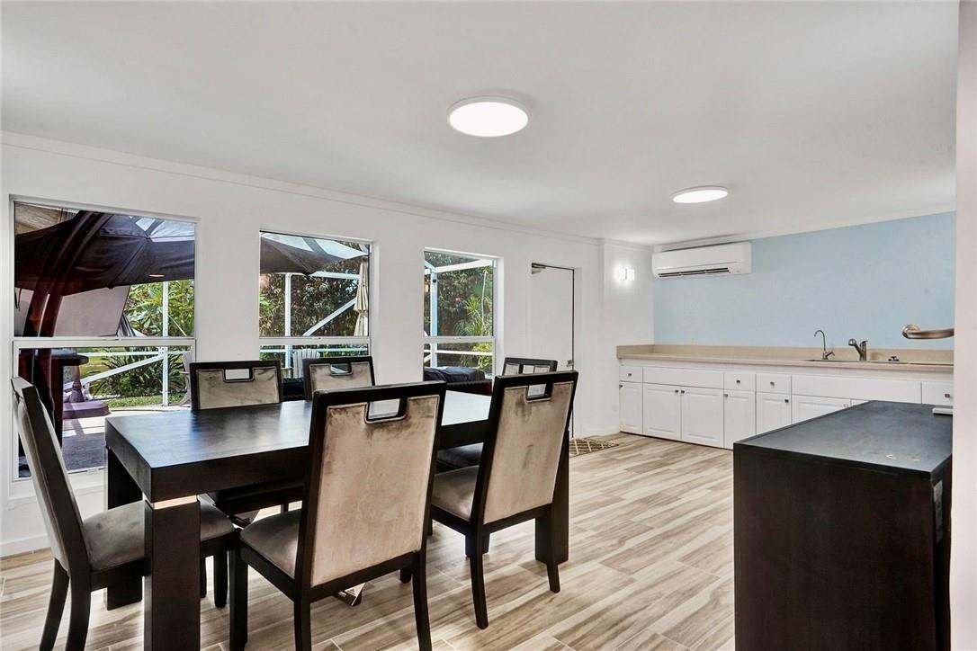 10066 Camelback Lane Boca Raton, FL 33498 - Photo 10 of 34 a view of a dining room with furniture and wooden floor