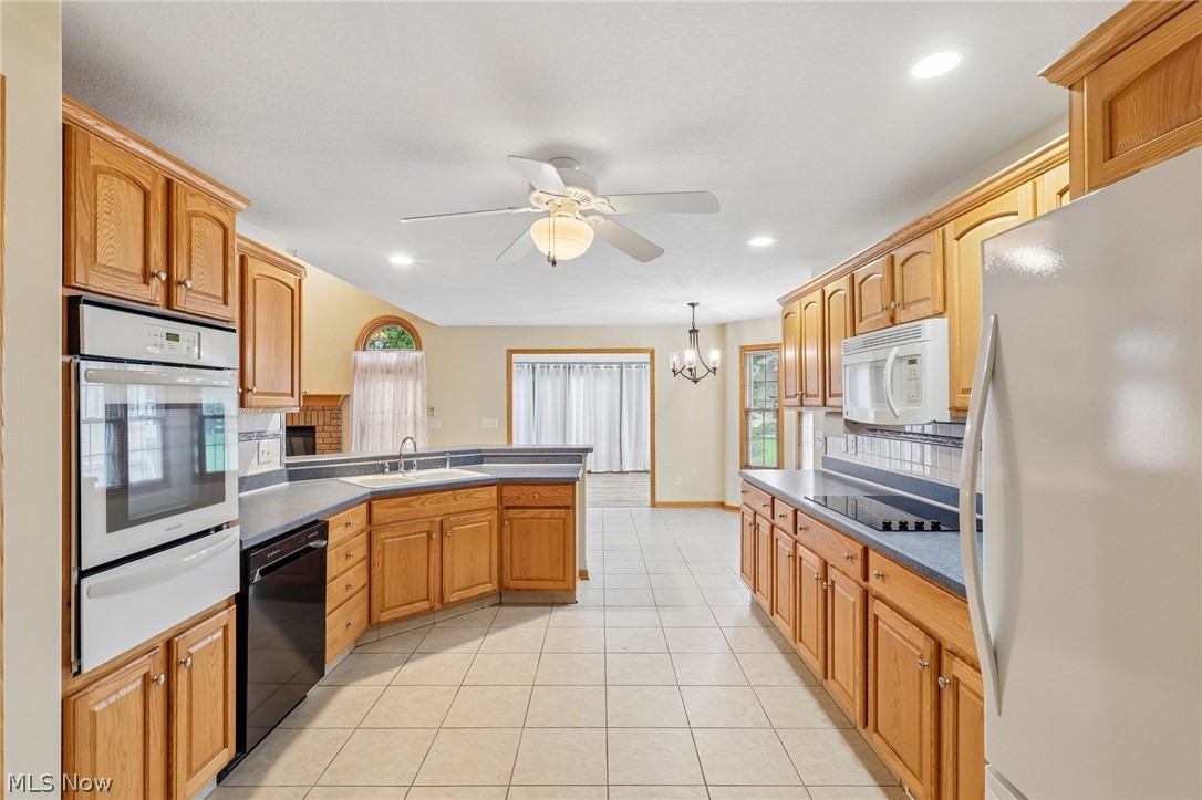 7007 Clingan Road, Unit 85 Youngstown, OH 44514 - Photo 17 of 46 Kitchen featuring tile flooring, wood-finish cabinetry, built-in double ovens, a built-in microwave, and recessed lighting