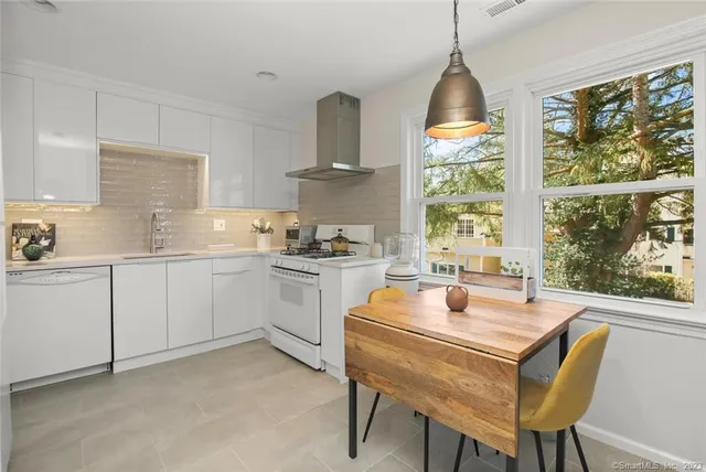 a kitchen with cabinets appliances a sink and a stove