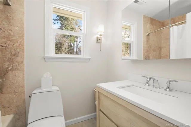 a bedroom with a bed window and wall painting