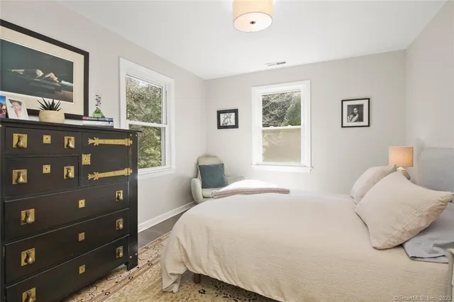 a front view of a house with a yard and potted plants