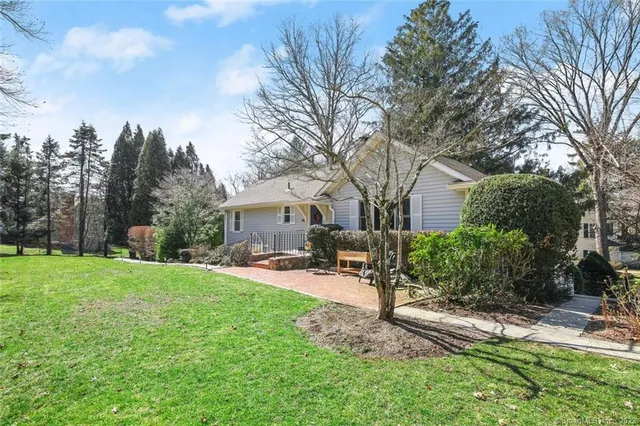 a view of a house with backyard and sitting area