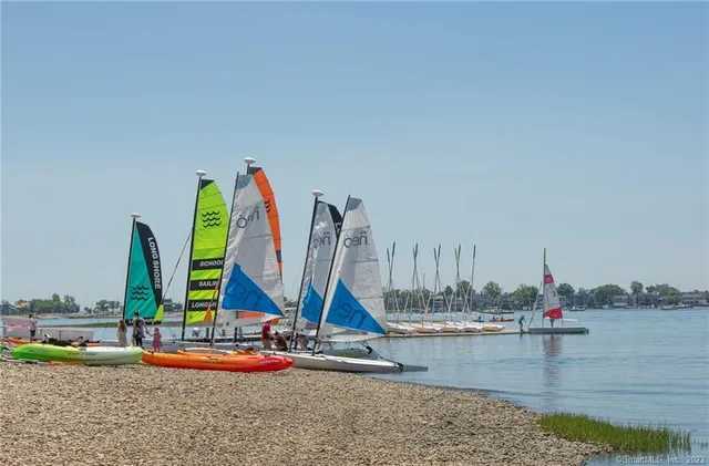 a view of a sink and dishwasher with wooden floor