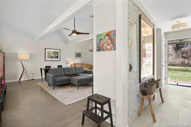 a living room with furniture flat screen tv and a fireplace