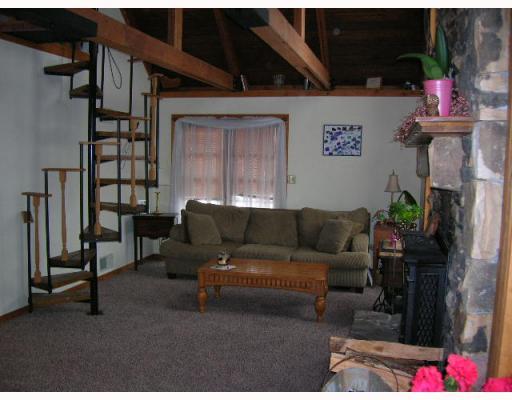 166 Redwood Road Acme, PA 15610 - Photo 3 of 16 Living Room. Vaulted and Beam Ceiling with Spiral Staircase to Master Bedroom and Den/Office