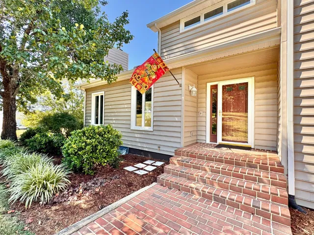 a view of a house with a small yard and plants