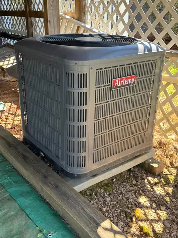 a dining room with furniture a chandelier and wooden floor