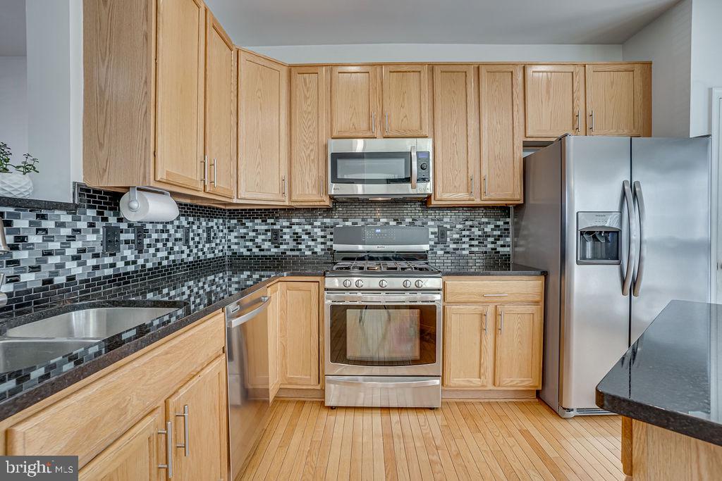 13262 Revillo Loop Woodbridge, VA 22191 - Photo 14 of 32 Modern kitchen with sleek finishes.