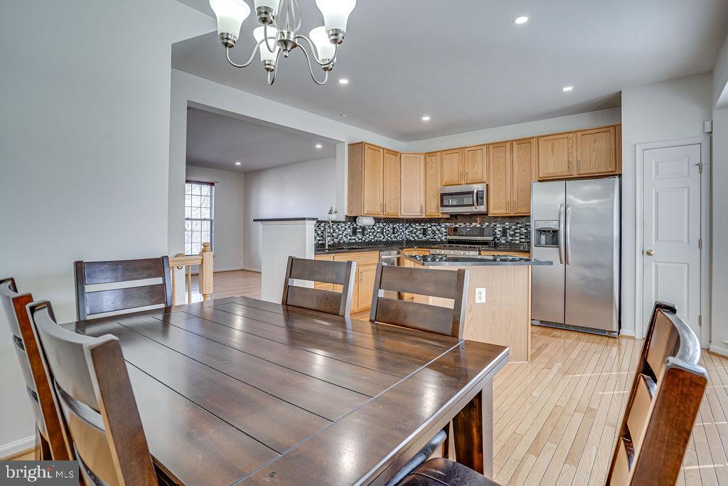 13262 Revillo Loop Woodbridge, VA 22191 - Photo 7 of 32 Modern kitchen with inviting dining area.