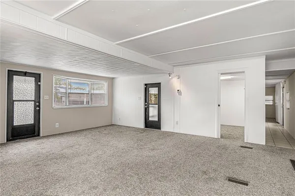 an empty room with a empty space and windows