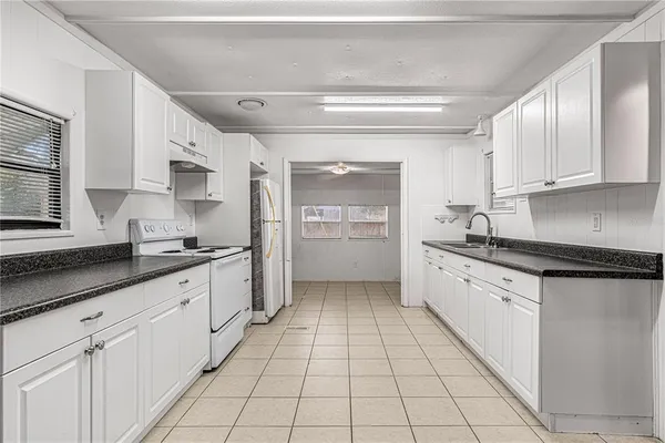 a kitchen with stainless steel appliances granite countertop a sink and cabinets