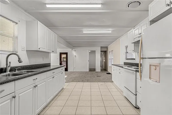 a kitchen with stainless steel appliances granite countertop a sink and cabinets