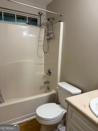 a bathroom with a toilet and a shower