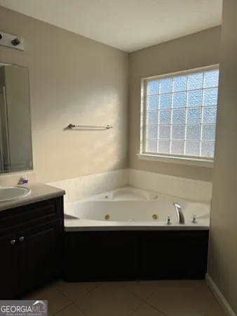a bathroom with a bathtub and a sink