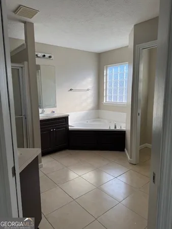 a bathroom with a bathtub and a sink
