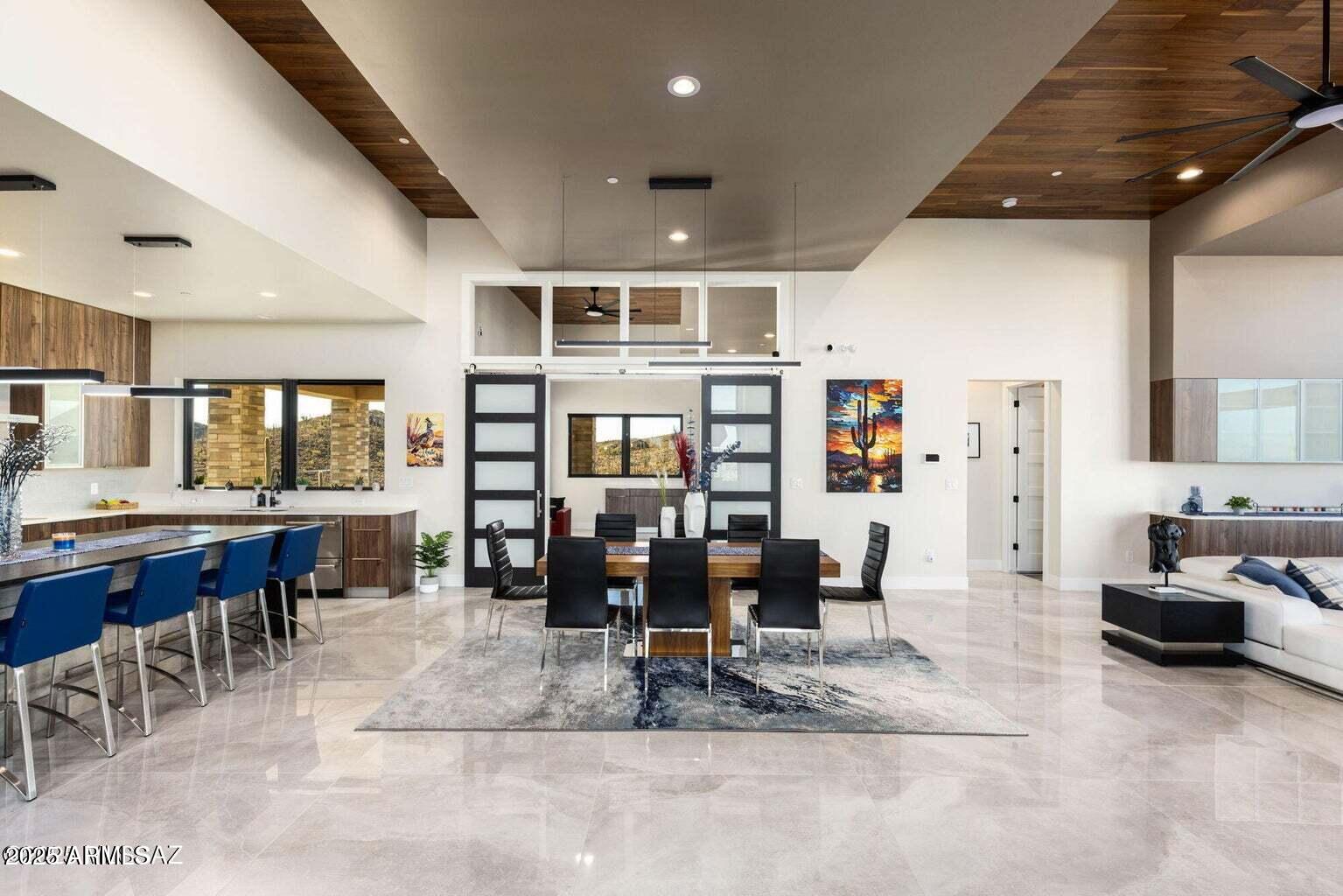 5901 West El Camino Del Cerro Tucson, AZ 85745 - Photo 12 of 50 a living room with furniture a dining table and chairs