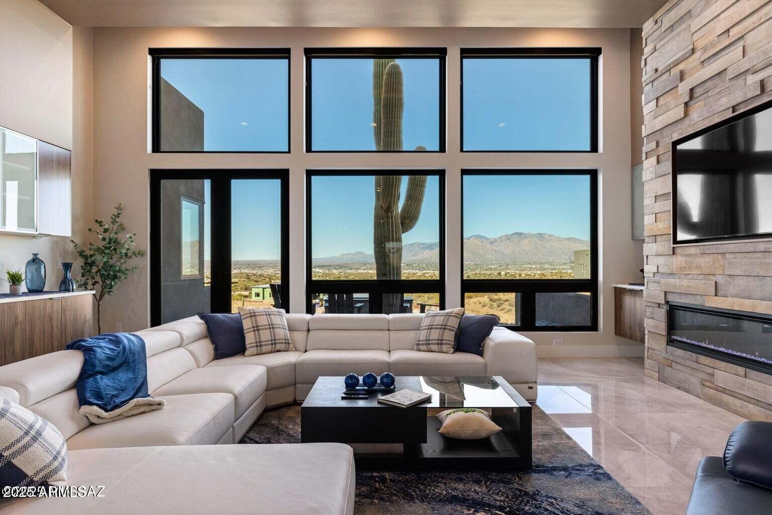 5901 West El Camino Del Cerro Tucson, AZ 85745 - Photo 13 of 50 a living room with furniture fireplace and a large window
