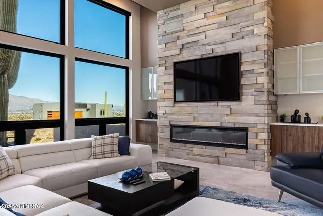 a living room with furniture a flat screen tv and a fireplace
