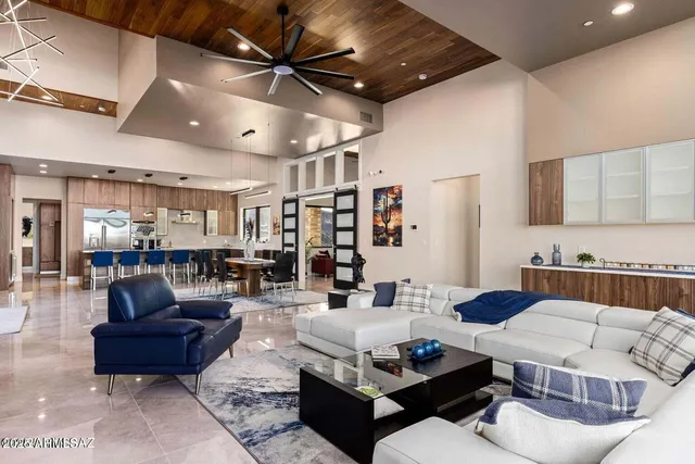 a living room with furniture and a chandelier