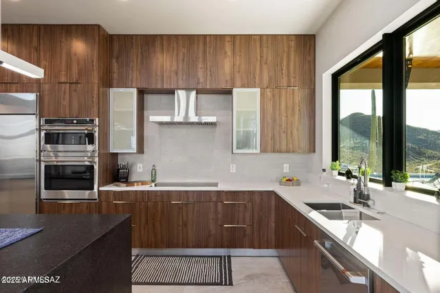 a kitchen with stainless steel appliances a sink stove and cabinets