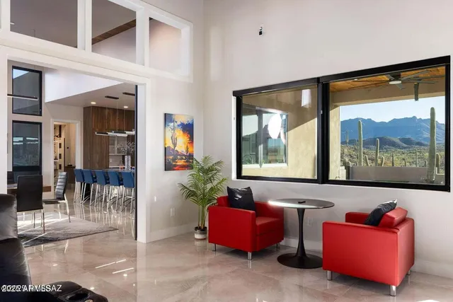 a living room with furniture and a floor to ceiling window