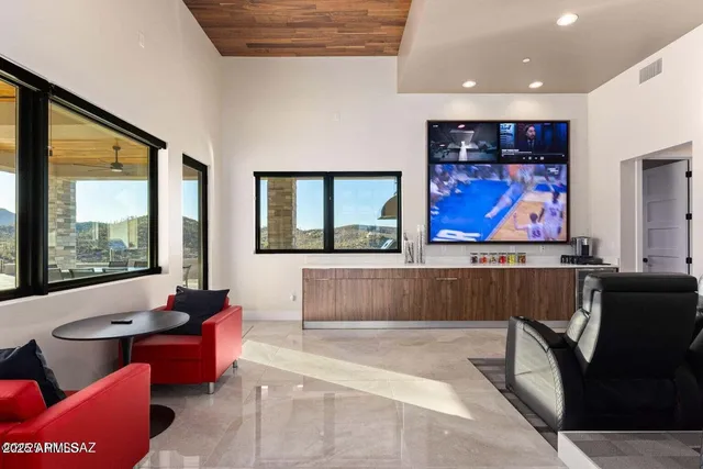 a living room with furniture bathtub and a large window