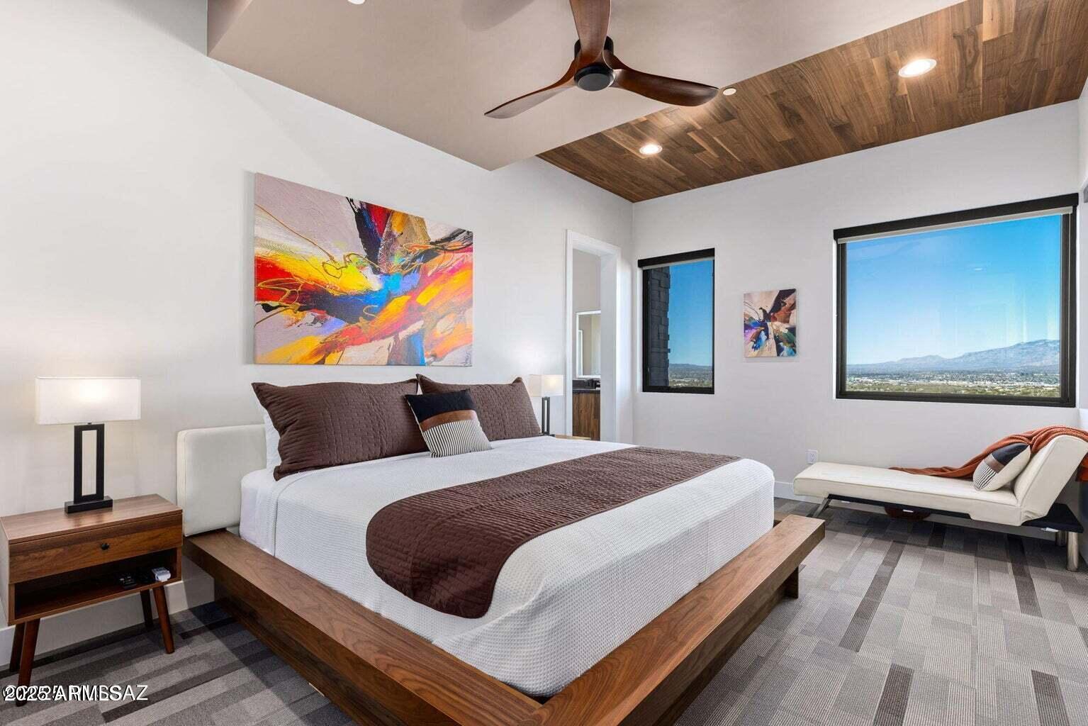 5901 West El Camino Del Cerro Tucson, AZ 85745 - Photo 21 of 50 a bedroom with a bed and wooden floor