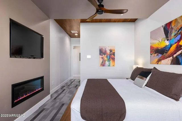 a bedroom with a bed and a television