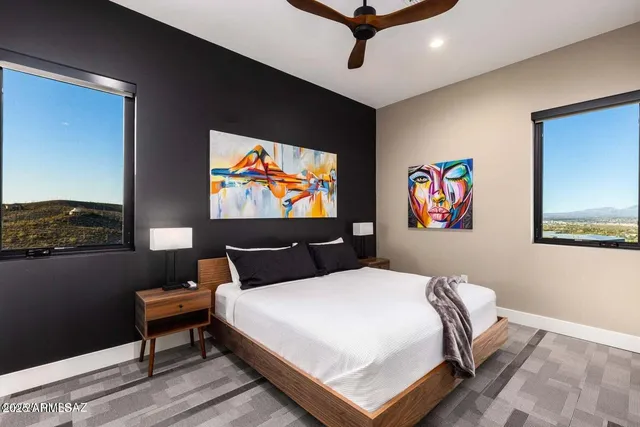 a bedroom with a bed and glass wall