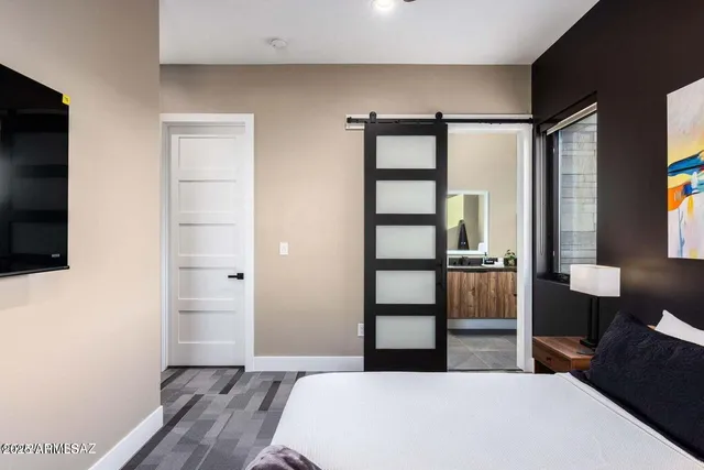 a bedroom with a bed and a flat screen tv