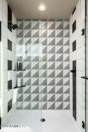 a bedroom with a large window and a flat screen tv