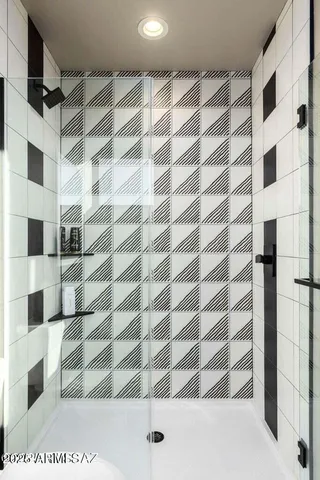 a bedroom with a large window and a flat screen tv