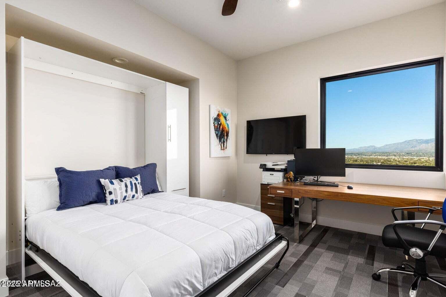 5901 West El Camino Del Cerro Tucson, AZ 85745 - Photo 32 of 50 a bedroom with a large window and a flat screen tv