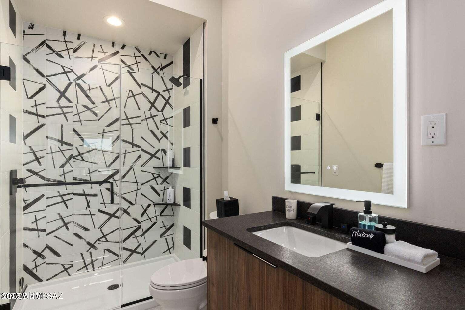 5901 West El Camino Del Cerro Tucson, AZ 85745 - Photo 33 of 50 a bathroom with a granite countertop sink and a mirror