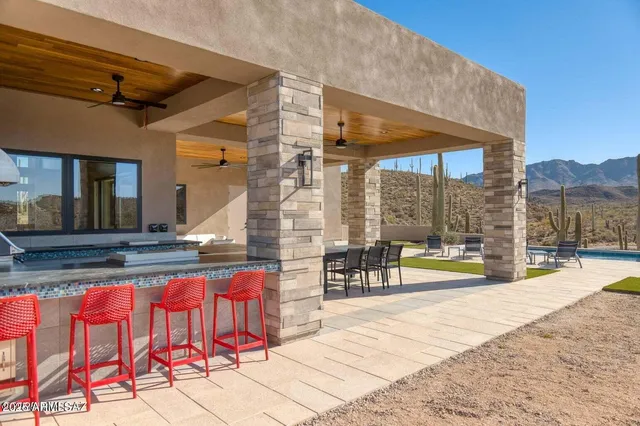 a view of a patio with a table chairs and a fire pit