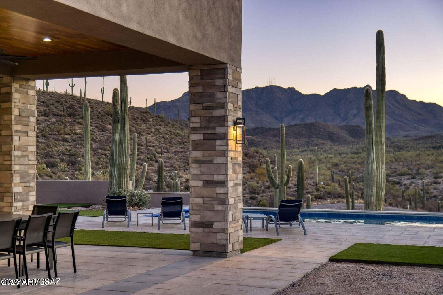 5901 West El Camino Del Cerro Tucson, AZ 85745 - Photo 43 of 50 a view of a patio with a table chairs and a fire pit