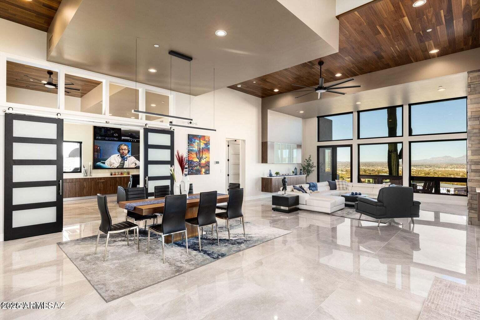 5901 West El Camino Del Cerro Tucson, AZ 85745 - Photo 6 of 50 a room with lots of tables a large window and chairs