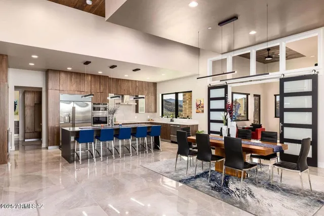 a kitchen with lots of wooden furniture and dining table