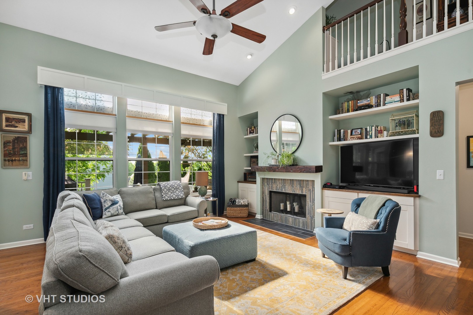 385 Sterling Circle Cary, IL 60013 - Photo 6 of 31 a living room with furniture a fireplace a flat screen tv and a large window