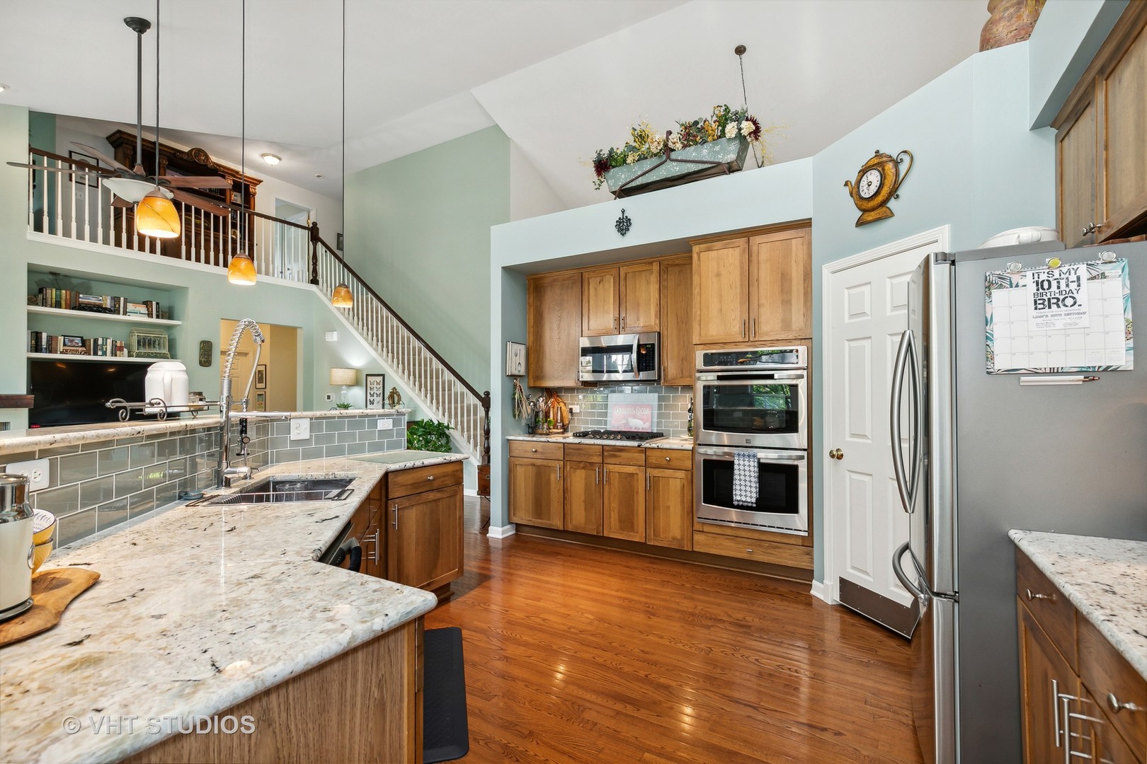 385 Sterling Circle Cary, IL 60013 - Photo 10 of 31 a kitchen with kitchen island granite countertop a refrigerator a oven a stove and a sink with wooden floor
