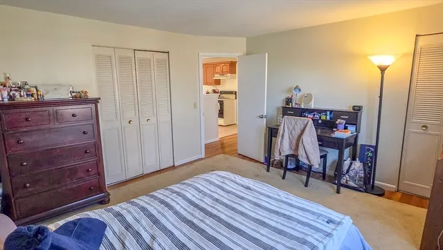a view of a bedroom with wooden floor and closet